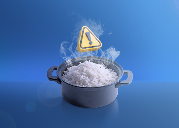 Why is the multiple heating of cooked rice dangerous?